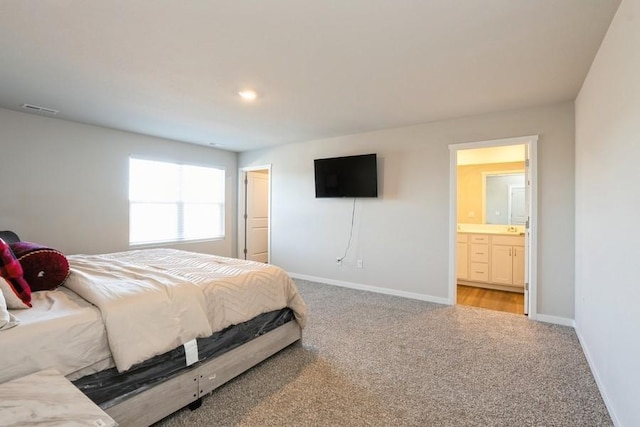 carpeted bedroom featuring connected bathroom