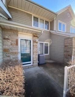 rear view of property with central AC and a patio area