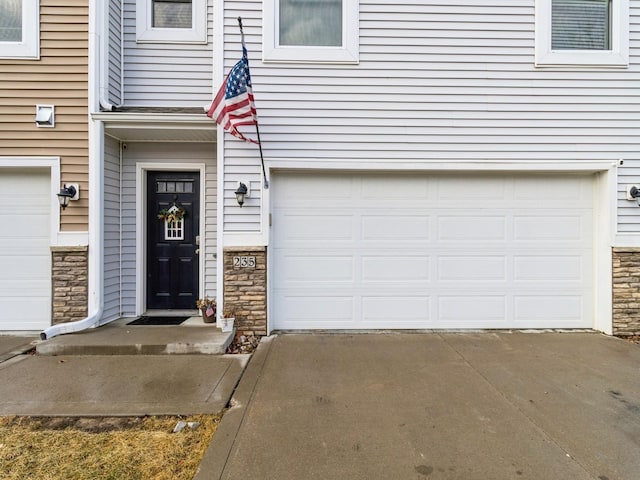 doorway to property with a garage