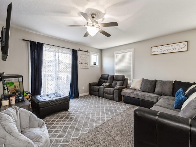 living room featuring ceiling fan and carpet