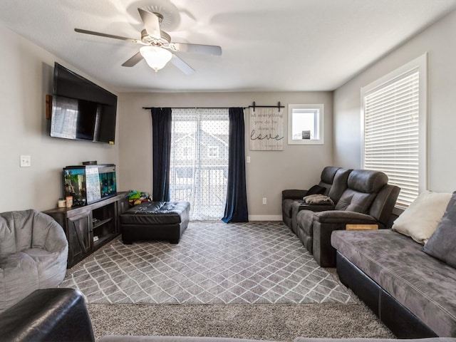 living room with carpet, a healthy amount of sunlight, and ceiling fan