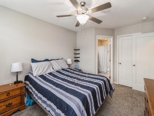 bedroom featuring ensuite bathroom, carpet flooring, and ceiling fan