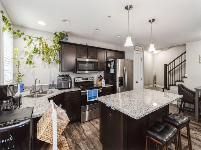 kitchen featuring dark brown cabinetry, sink, dark wood-type flooring, and stainless steel appliances