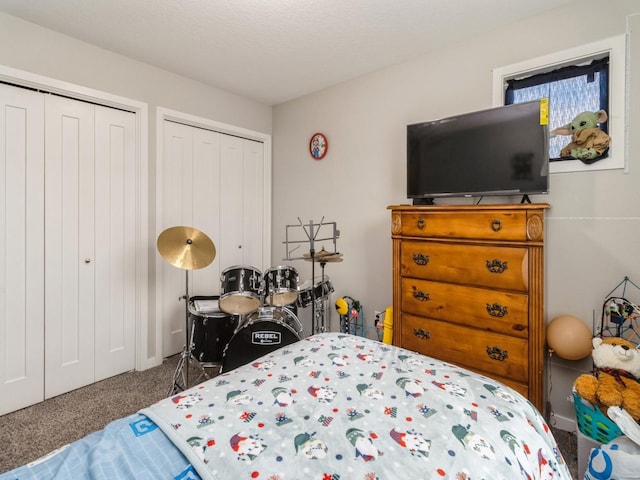 carpeted bedroom featuring two closets