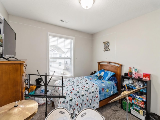 carpeted bedroom featuring a textured ceiling