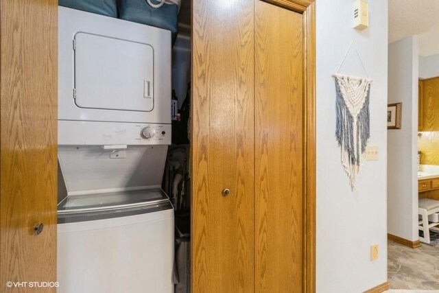 laundry room featuring stacked washer and dryer