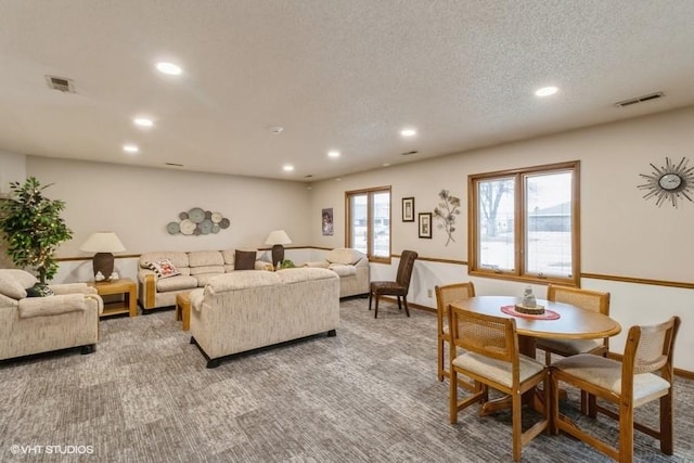 carpeted living room with a textured ceiling