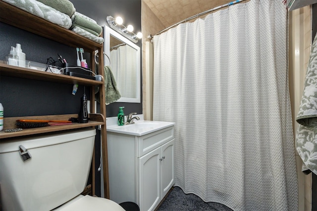 bathroom with vanity, toilet, and curtained shower