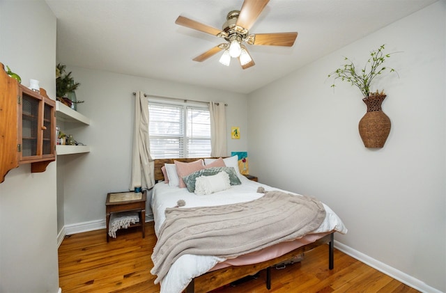 bedroom featuring hardwood / wood-style floors and ceiling fan