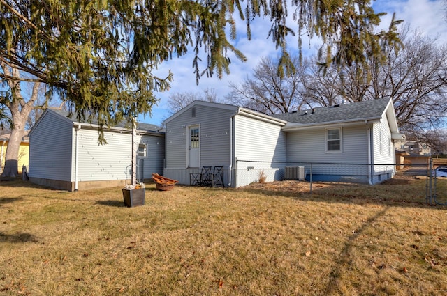 back of house featuring cooling unit and a yard