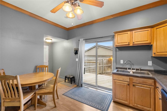 kitchen featuring dishwasher, sink, ornamental molding, ceiling fan, and light wood-type flooring