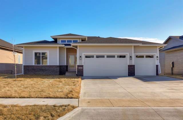 prairie-style house with a garage and a front yard