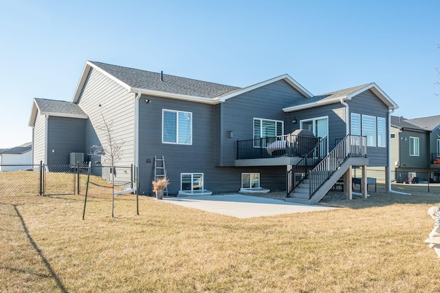 back of house with central AC unit, a lawn, and a patio