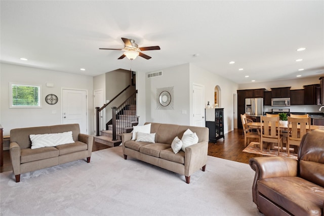 living room with ceiling fan and light hardwood / wood-style floors