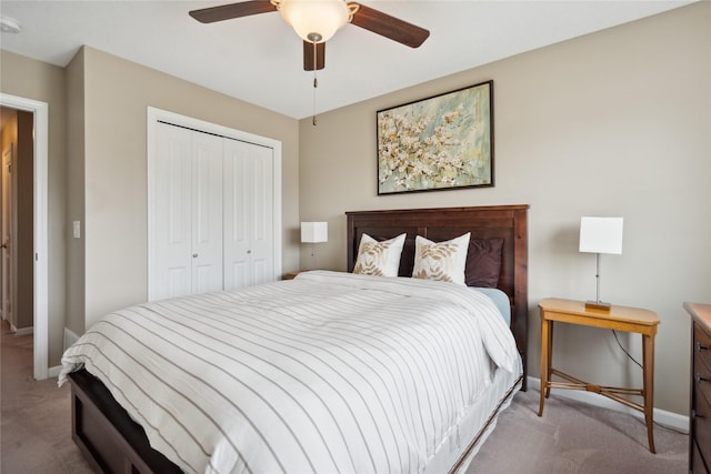 carpeted bedroom with ceiling fan and a closet