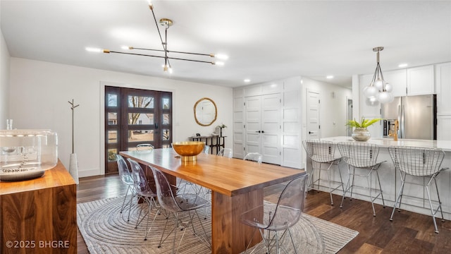 dining area featuring dark hardwood / wood-style flooring and a chandelier