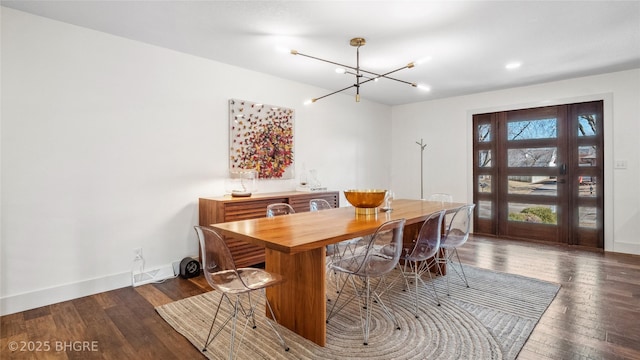 dining area featuring an inviting chandelier and dark hardwood / wood-style flooring