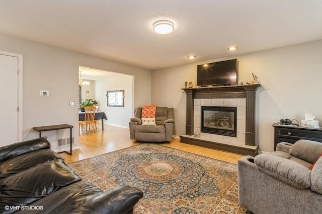 living room featuring a fireplace and light hardwood / wood-style floors