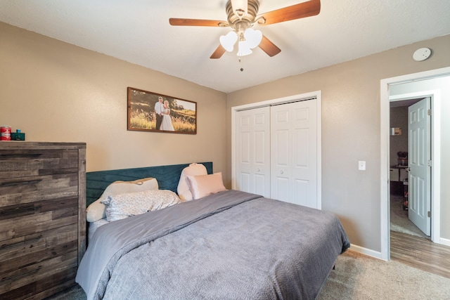 carpeted bedroom featuring a closet and ceiling fan