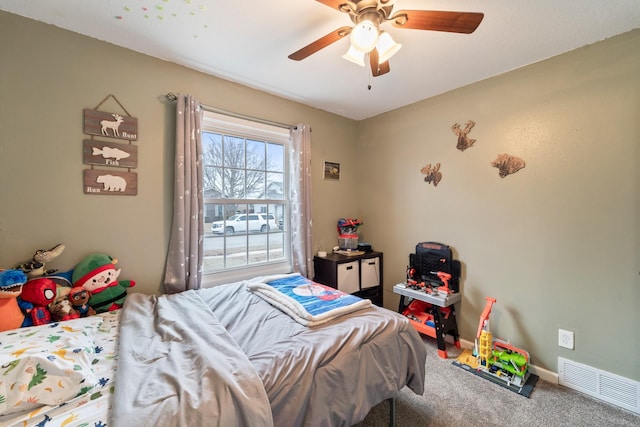 bedroom featuring ceiling fan and carpet