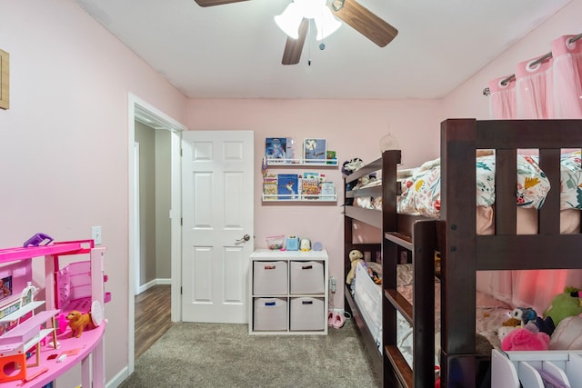 bedroom featuring ceiling fan and dark carpet