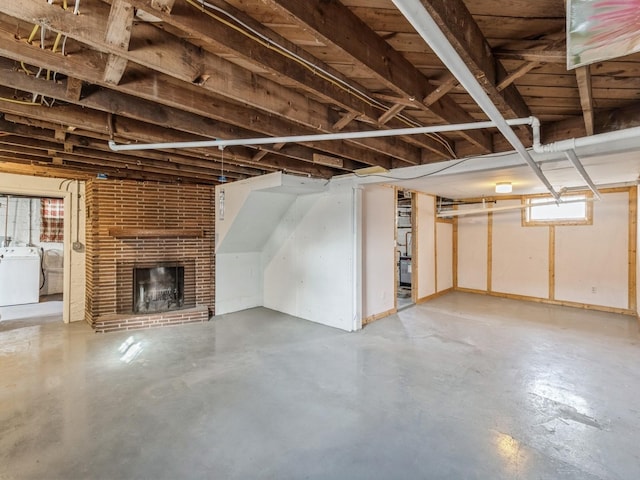 basement with a fireplace and washer / clothes dryer