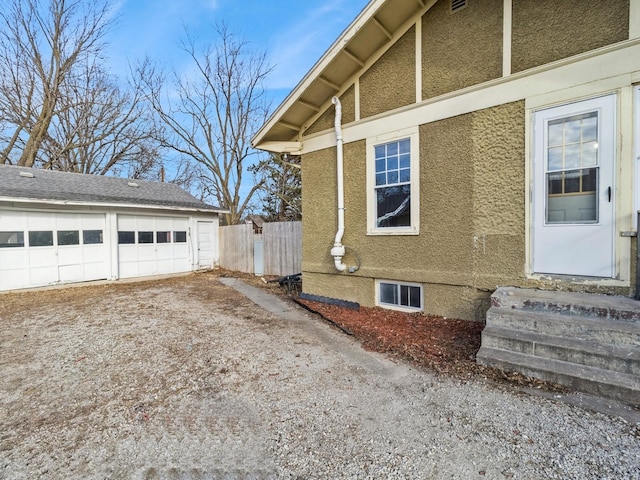 view of home's exterior with a garage and an outdoor structure