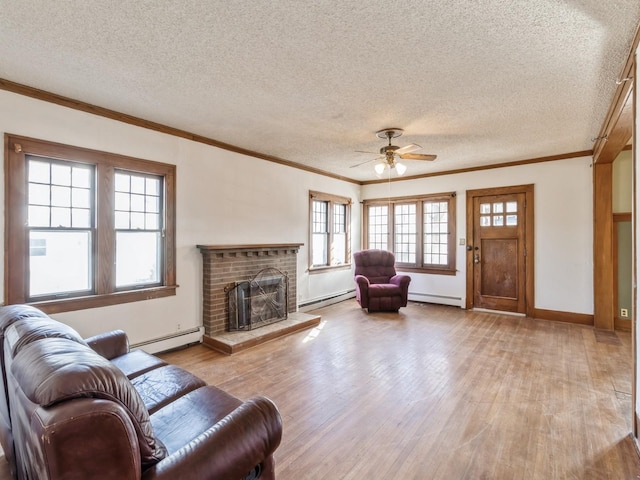 living room featuring a baseboard radiator, a brick fireplace, and light wood-type flooring