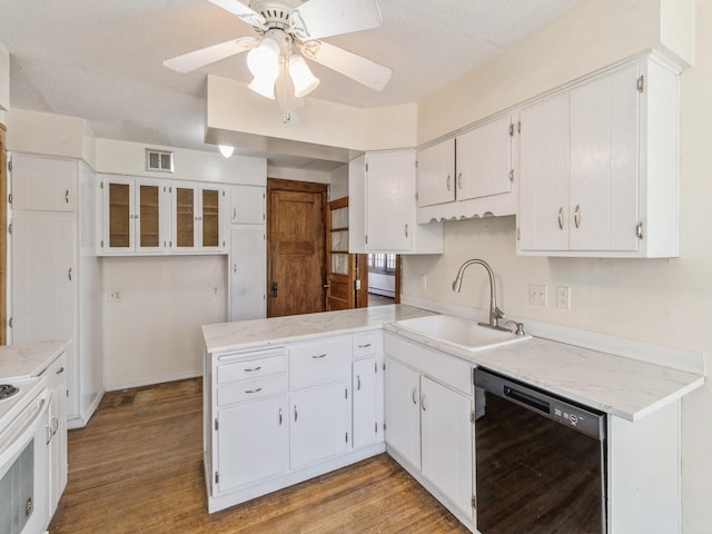 kitchen with sink, a textured ceiling, light wood-type flooring, black dishwasher, and white cabinets