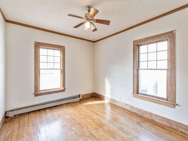 unfurnished room featuring hardwood / wood-style flooring, ornamental molding, a textured ceiling, and a baseboard heating unit