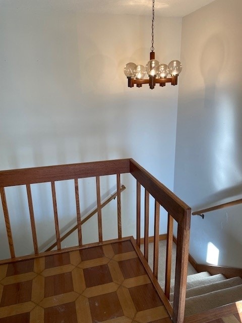 stairway with a chandelier