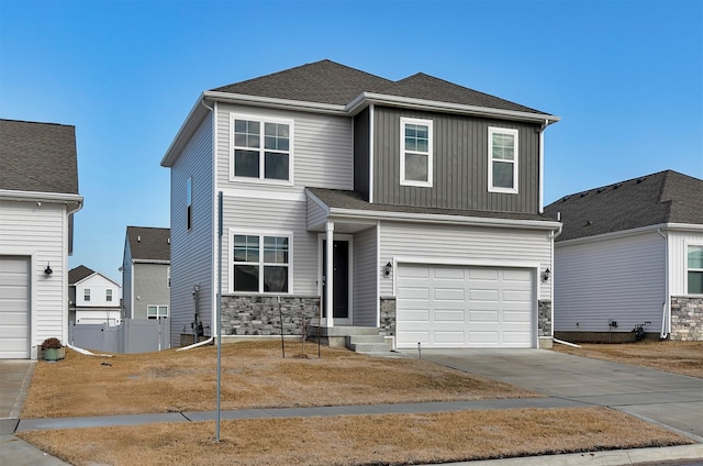 4308 NE 15th St, Ankeny, IA 50021 - view of front facade with concrete driveway, stone siding, board and batten siding, and an attached garage
