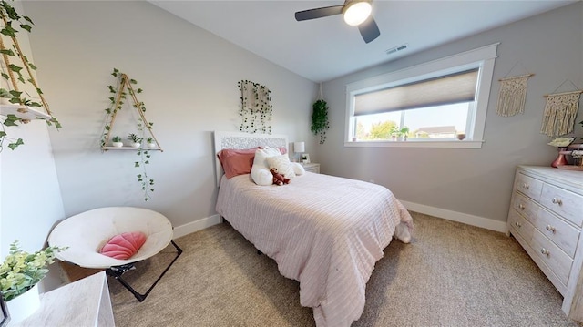 bedroom featuring lofted ceiling, light colored carpet, and ceiling fan