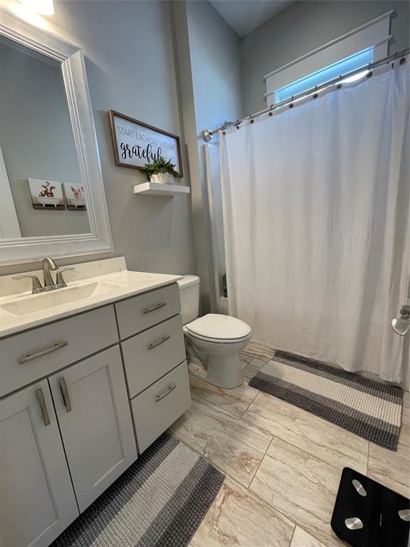 bathroom featuring vanity and toilet