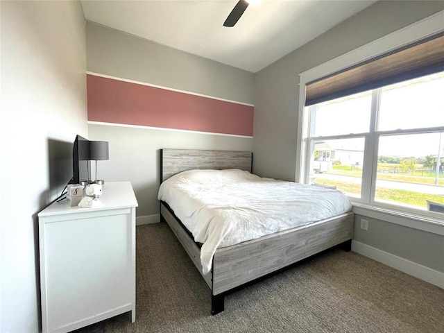 bedroom featuring ceiling fan and dark colored carpet