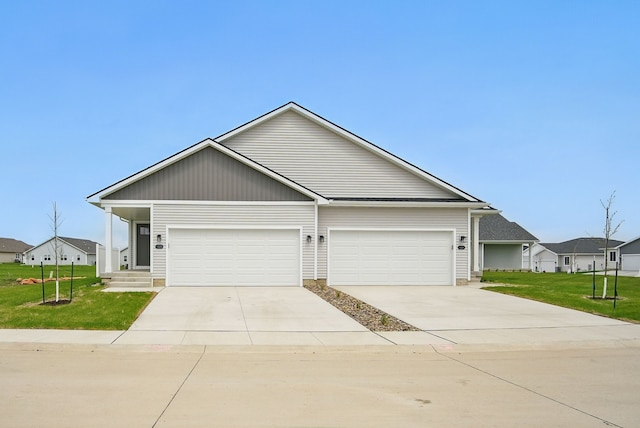 view of front of property with a front yard, driveway, and an attached garage