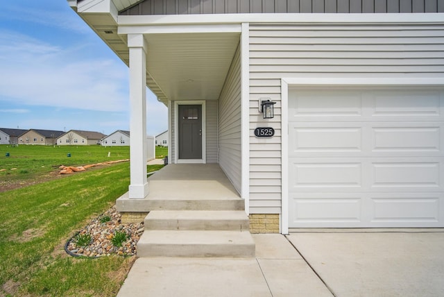 entrance to property with a lawn