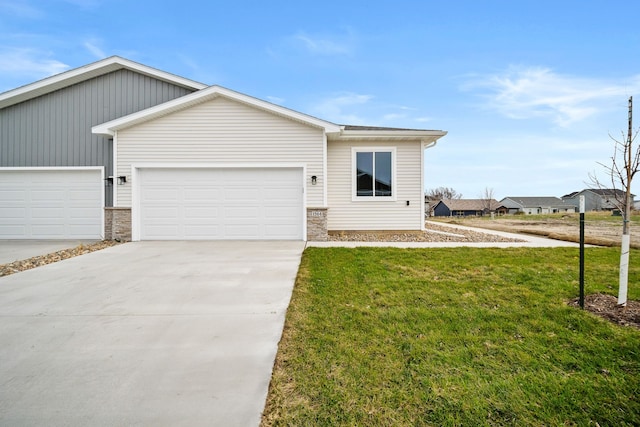 view of front of property with a garage and a front lawn