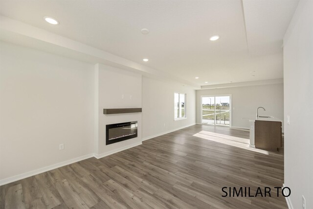 unfurnished living room featuring hardwood / wood-style flooring