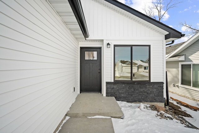 view of snow covered property entrance