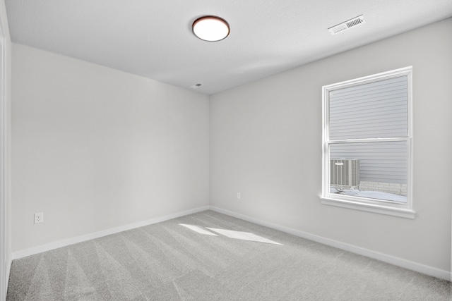 unfurnished room with baseboards, visible vents, and carpet flooring