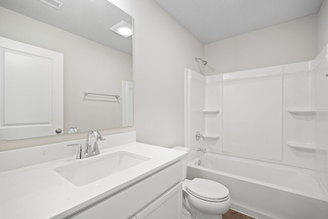 bathroom featuring shower / tub combination, vanity, and toilet