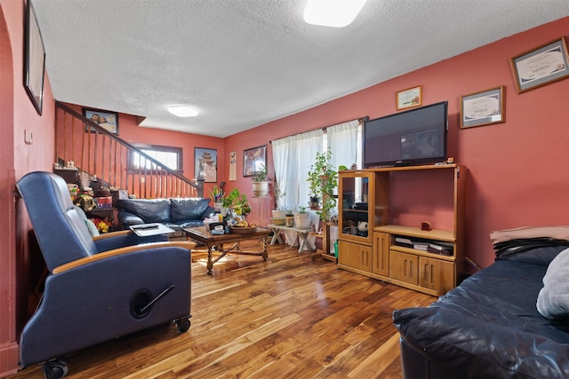 living room featuring hardwood / wood-style flooring and a textured ceiling