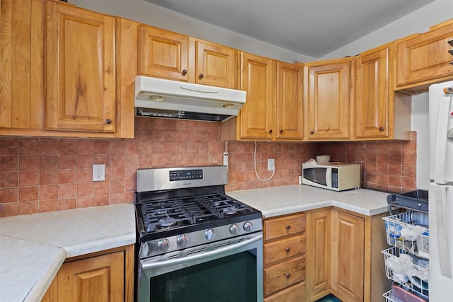 kitchen with white appliances and backsplash