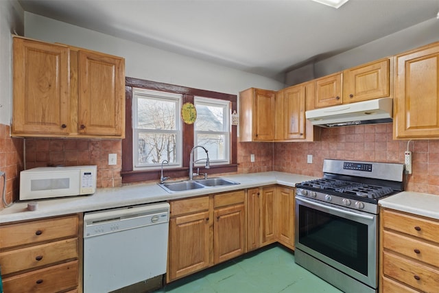 kitchen featuring tasteful backsplash, sink, and white appliances