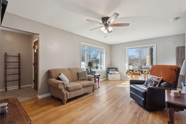 living room featuring ceiling fan and light hardwood / wood-style flooring