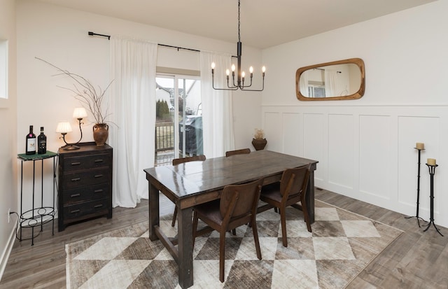 dining room with hardwood / wood-style floors and a notable chandelier