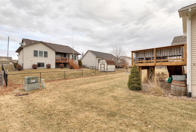 view of yard featuring a storage unit and a deck