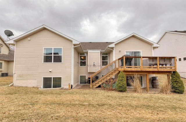 rear view of property featuring a deck and a lawn