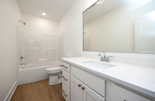 full bathroom with vanity, bathtub / shower combination, hardwood / wood-style floors, and toilet